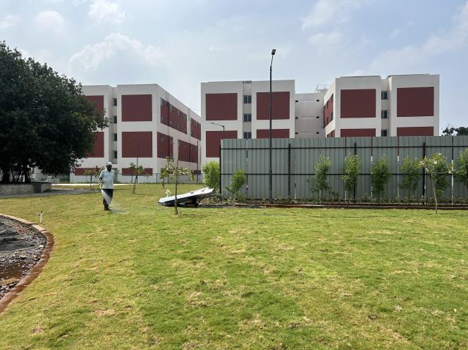 SALCOMP facility — building exterior with landscaped lawn